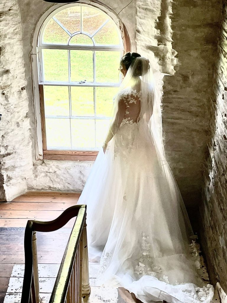 Bride and groom on wedding day showing beautifully fitted wedding dress altered by Zen