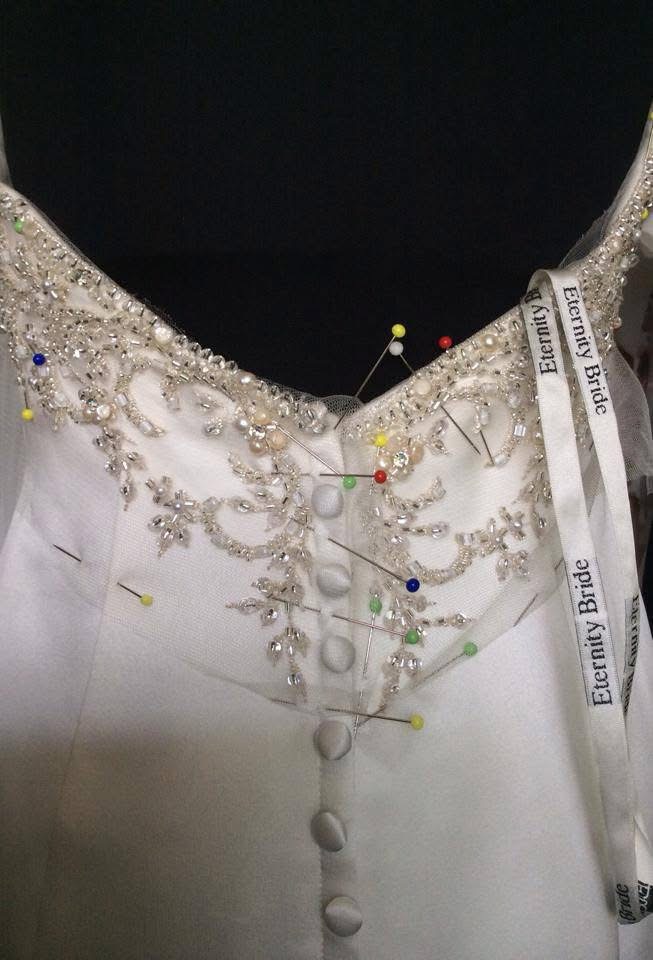 wedding dress neckline alteration with hand beading detail placed on dress