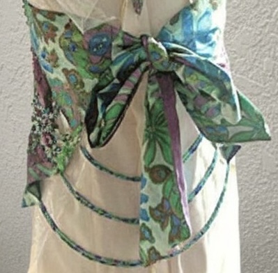 Back detail of bespoke silk dress with sculptural bow and cascading beaded strands