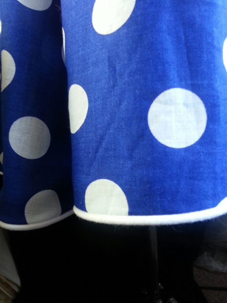 Piped hem detail polka dot dress couture finish