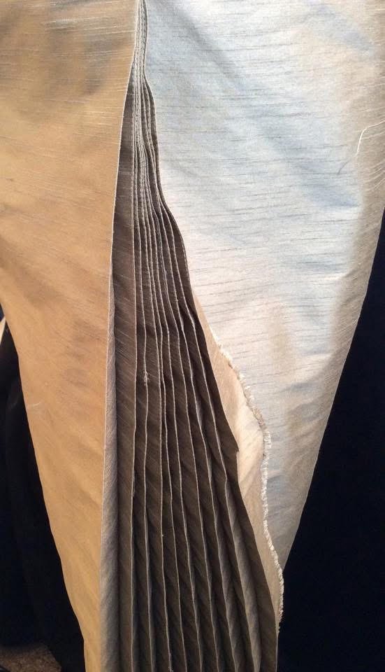 front view of bespoke  with clean pencil skirt and structured bodice in gold raw silkpleats detail view 