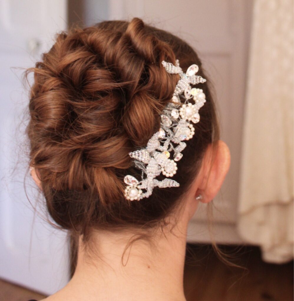 bride wearing bespoke crystal bridal headpiece in styled hair