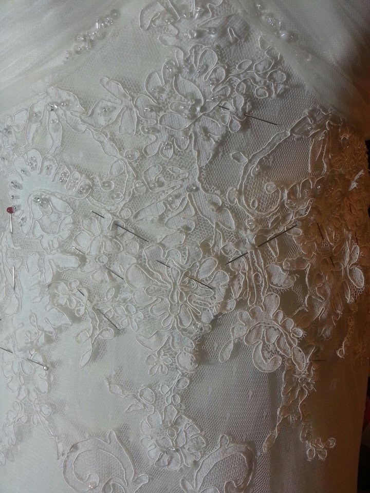 reattaching lace applique by hand on bridal gown alteration