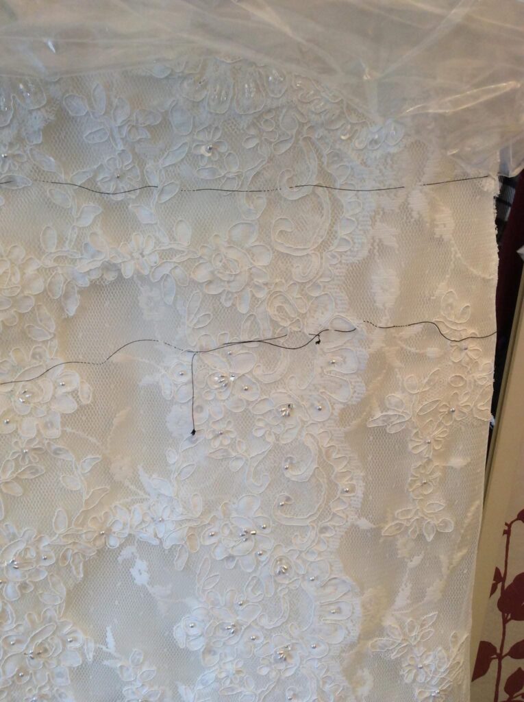 bridal lace appliqué removal before alteration close up