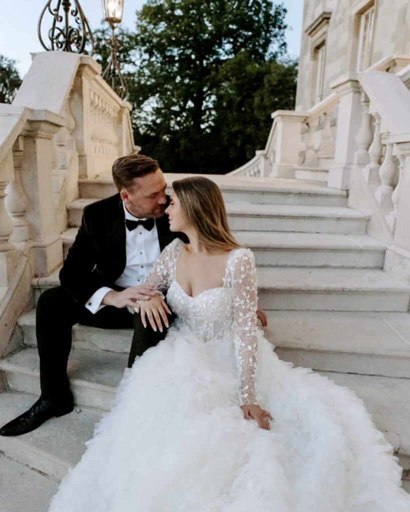 Bride and groom sitting on stair case