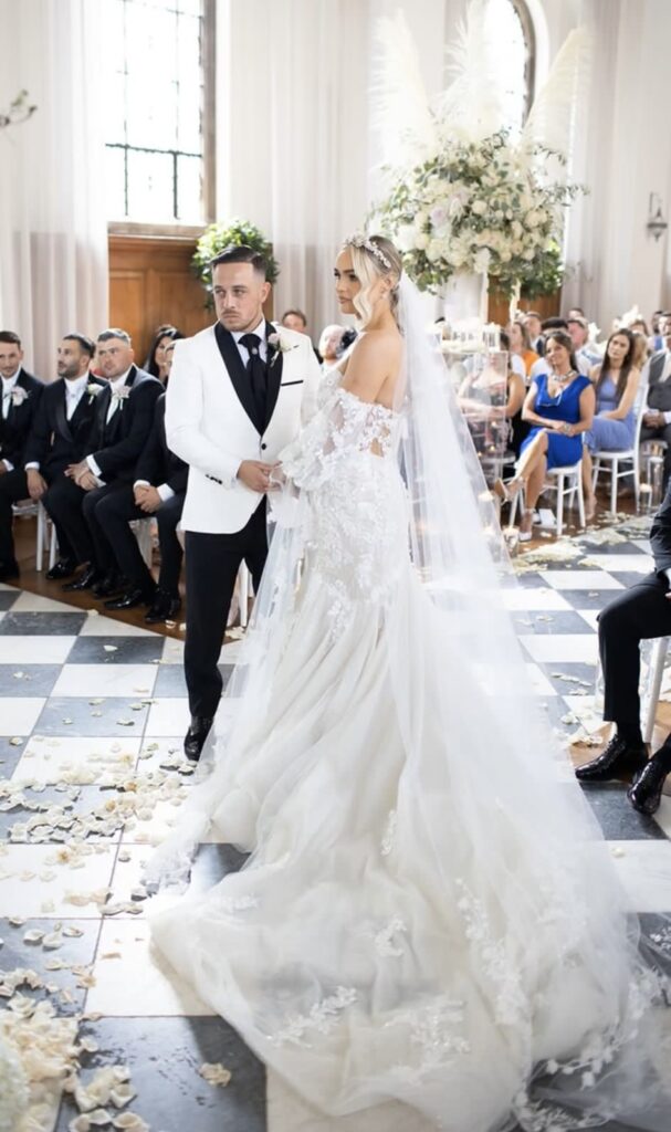 Martina Liana wedding dress with veil and lace detailing