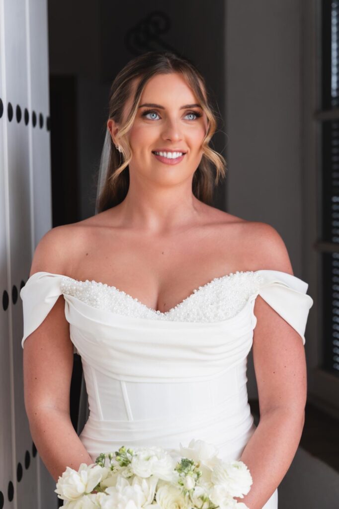 Minimalist crepe wedding dress with Bardot sleeves after couture bridal alterations for Marbella wedding