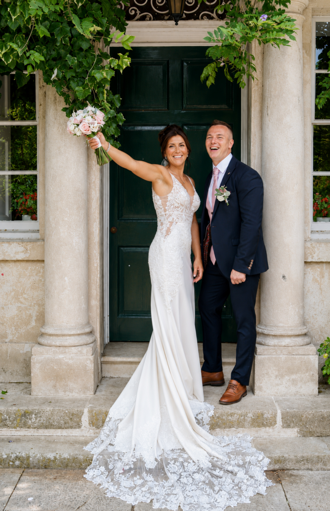 Bride and groom celebrating after bridal alterations and groom suit tailoring
