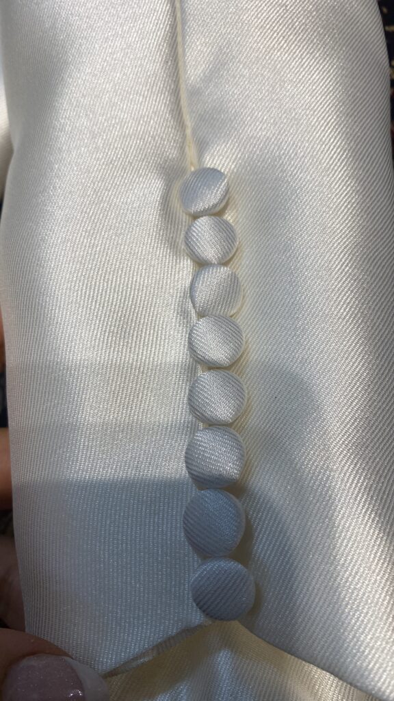 detail of buttons and loops at hem 