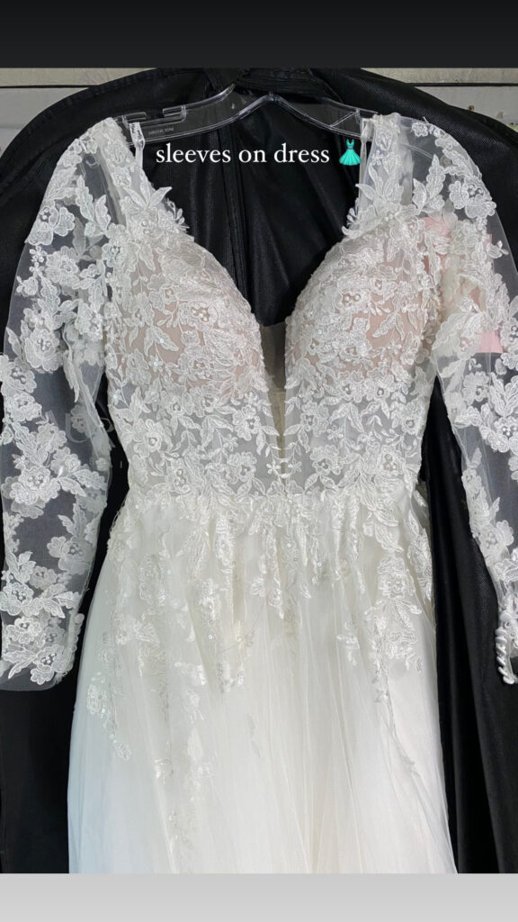 Bespoke tulle sleeves with lace appliqué and button and loops at hem added to a Crystal Palace bride