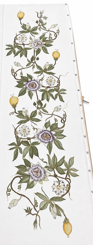 Close-up detail of hand-painted passion flower on silk scarf with botanical vine artwork