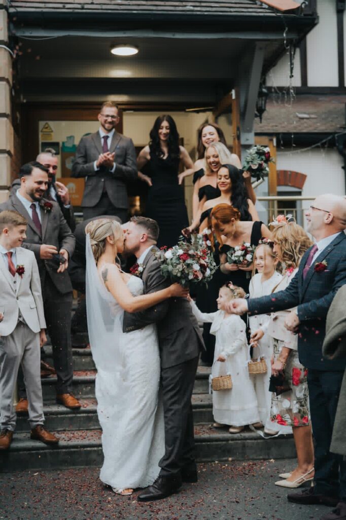 Bride and groom kissing passionately