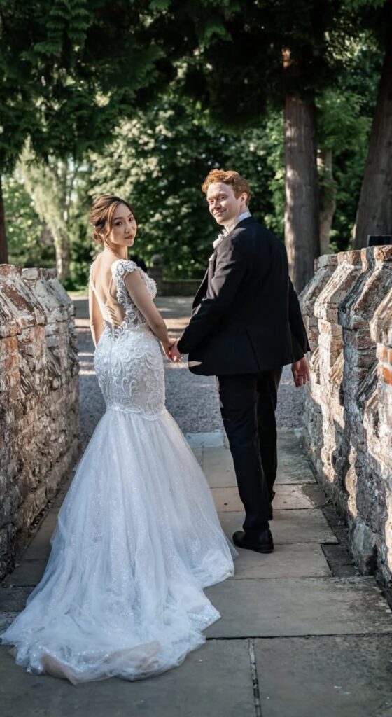 Champagne Riki Dalal wedding dress with heavy embellishment and couture bridal alterations photographed with bridesmaids and parasols in evening sunlight