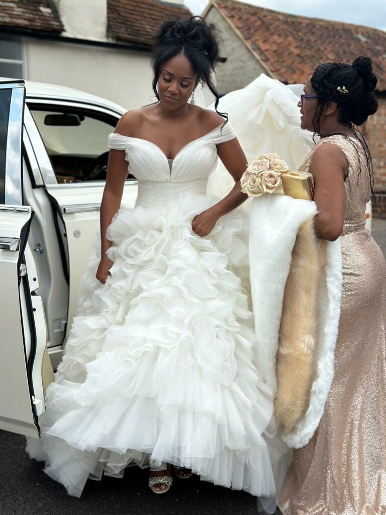 Bride wearing altered Ronald Joyce wedding dress during Essex wedding reception