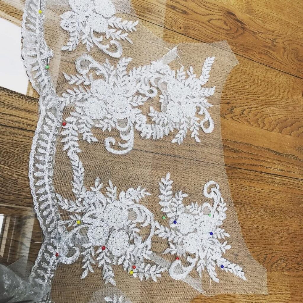 handsewn lace pieces cut to shape then stitched all by hand on the tulle