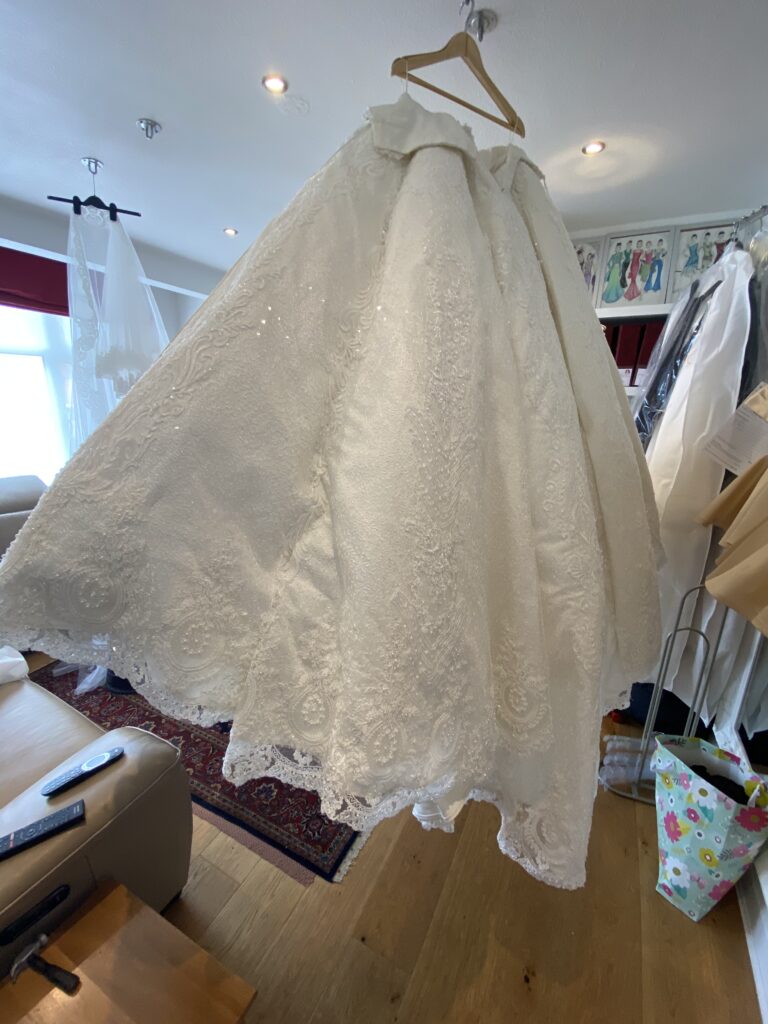 Before gypsy wedding dress alterations showing side view of skirt Swarovski crystal ballgown