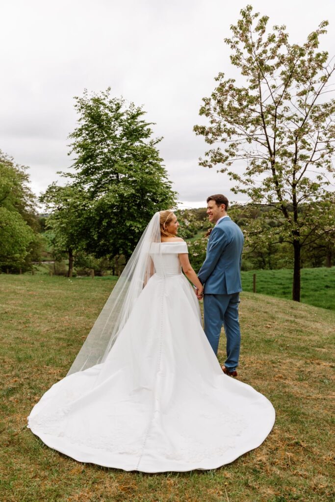Couture Stella York bridal alterations with structured satin bodice and cathedral veil