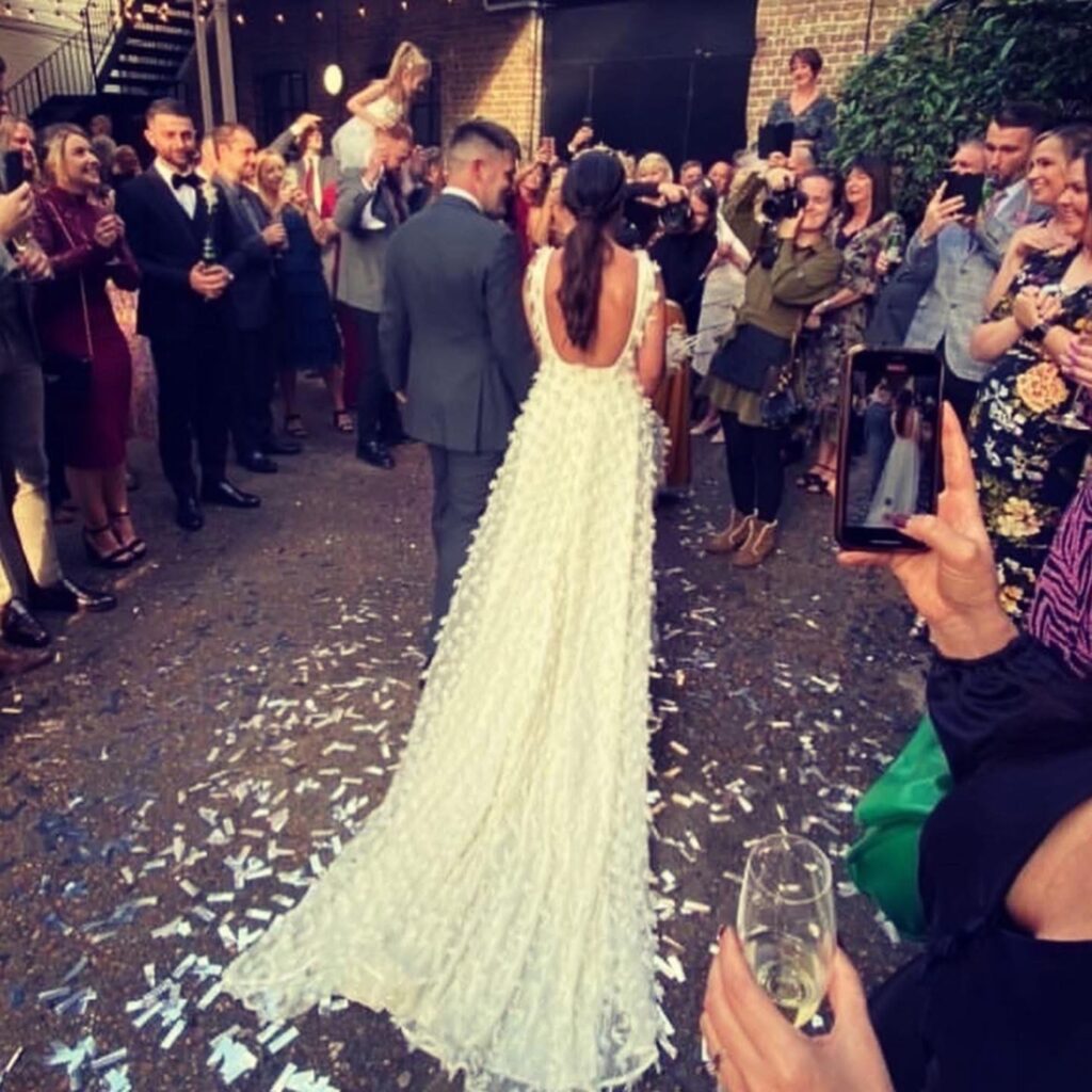 Luxury bridal alterations London fitted feather wedding gown