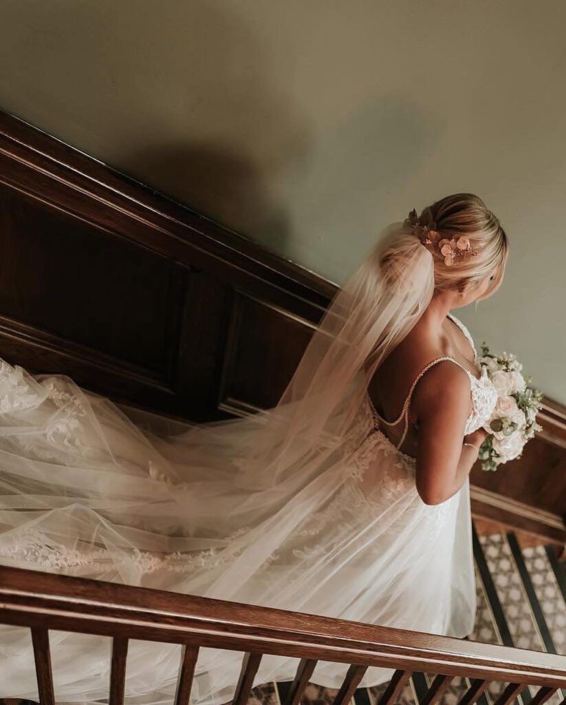 Minimalist satin wedding dress with cathedral veil following couture bridal alterations for a Warlingham bride