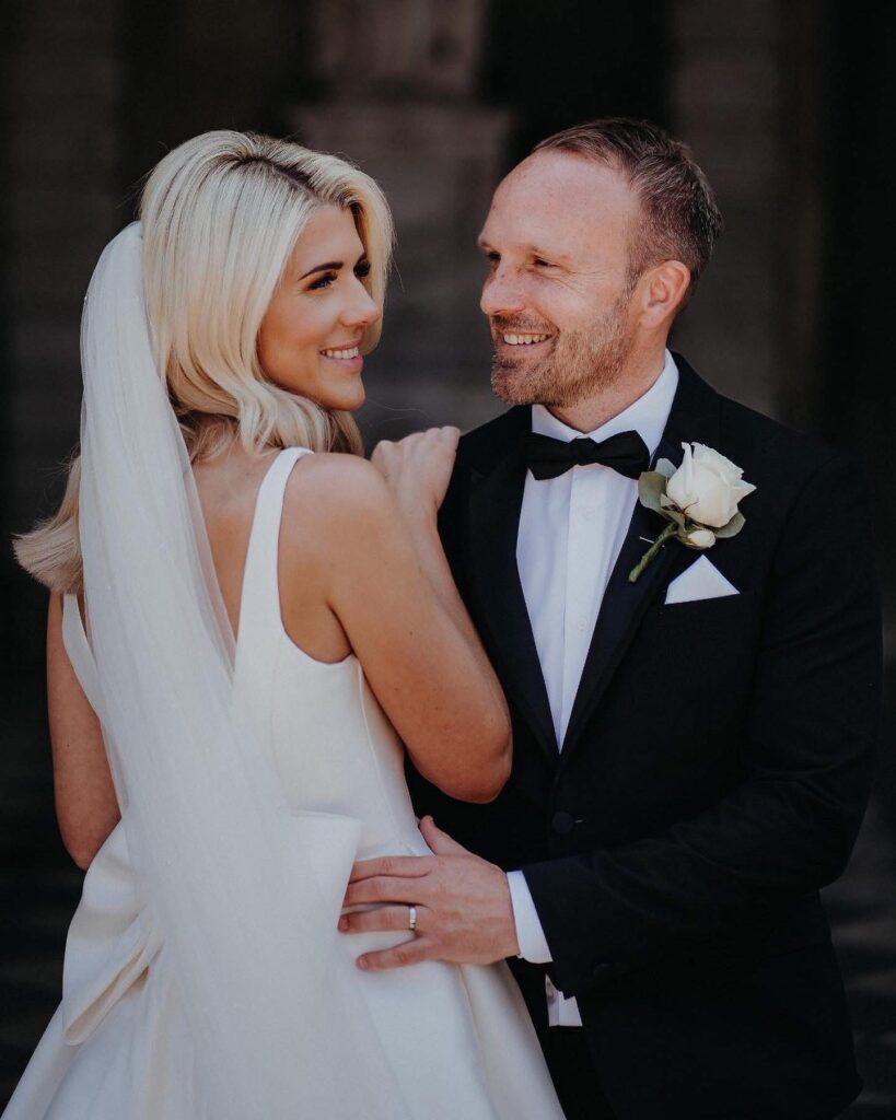 Bride wearing lace fitted wedding dress after couture bridal alterations from a Sutton Surrey bridal studio