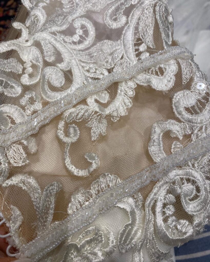 Beaded trim repaired all along waist restitched by hand