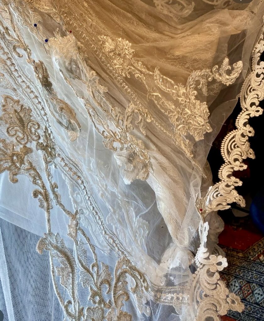 Beaded lace hem reconstruction on a heavily embellished wedding dress