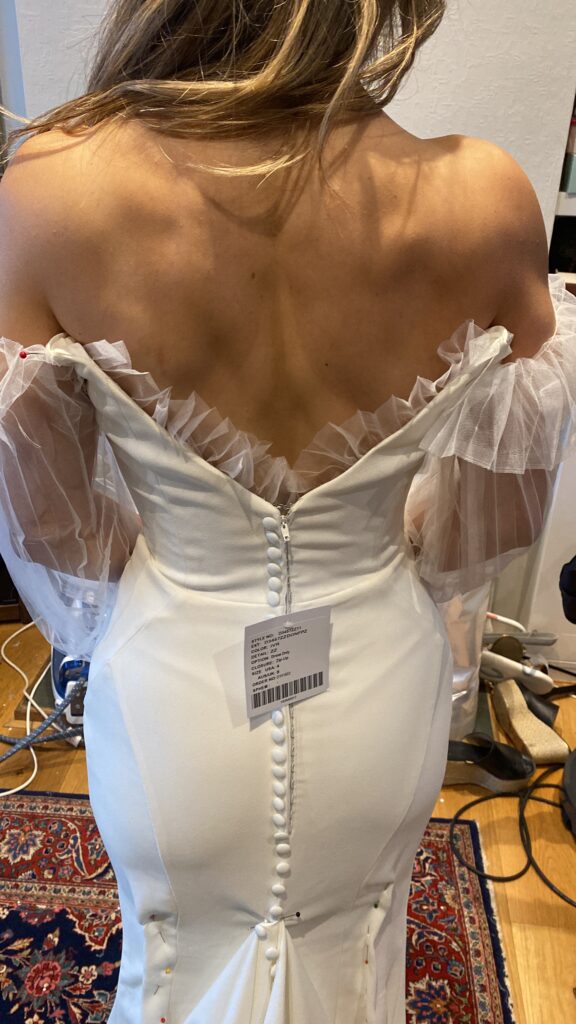 Back fitting during couture bridal sleeve reconstruction using pleated illusion tulle
