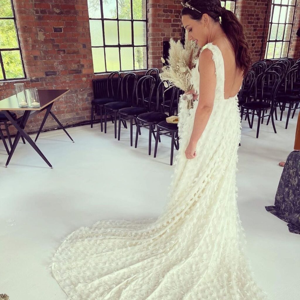 Structural bridal alterations on feather textured couture wedding dress