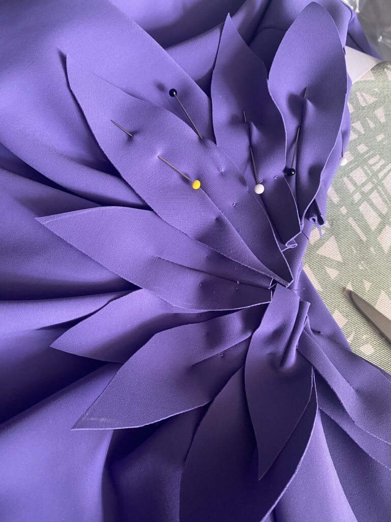 Fabric petals cut from the hem of the dress for a bespoke floral appliqué