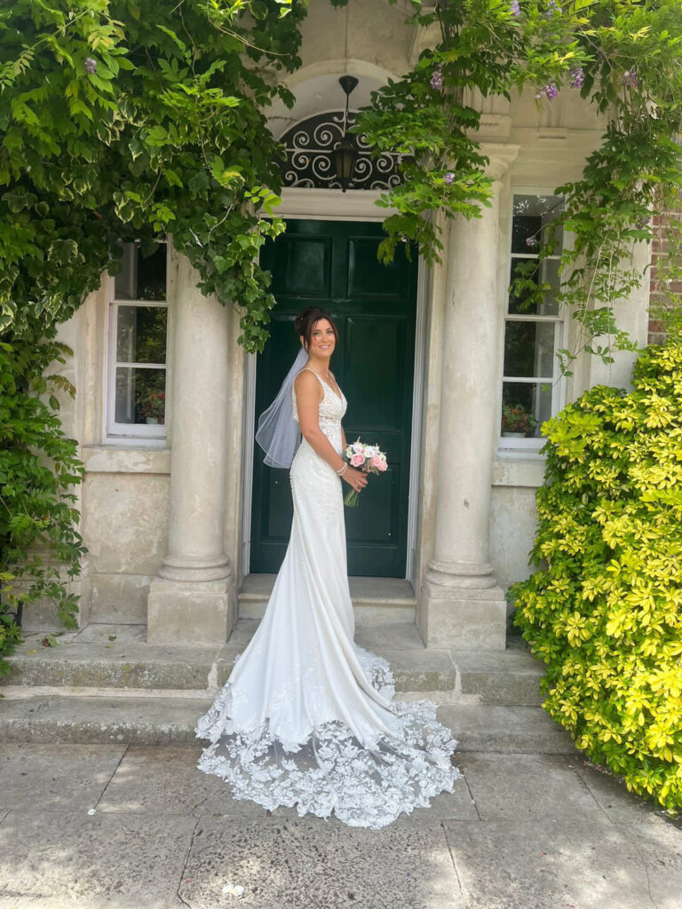Bride wearing an Essense Of Australia wedding dress after couture bridal alterations and sample sale gown resizing in Surrey