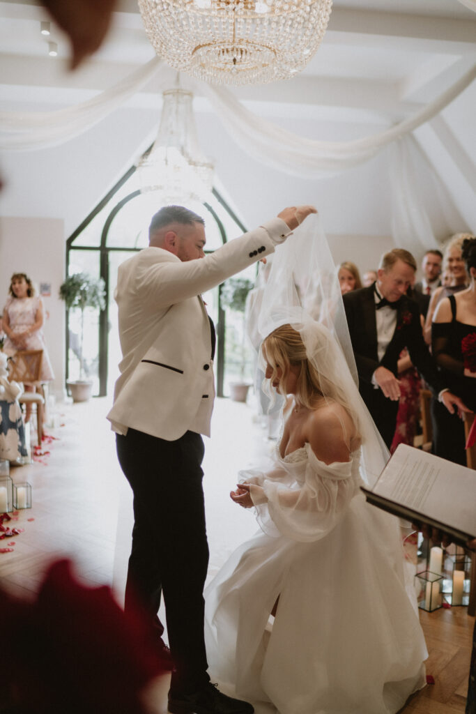 Bride wearing altered Essense of Australia gown during wedding ceremony