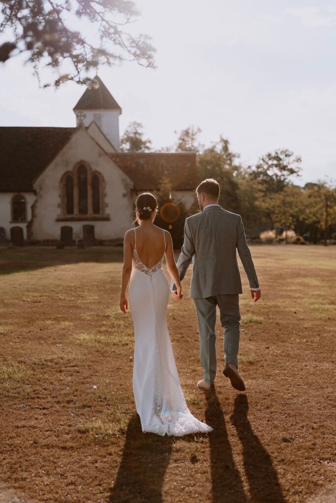 Bride and groom enjoying their walk on a sunny wedding day