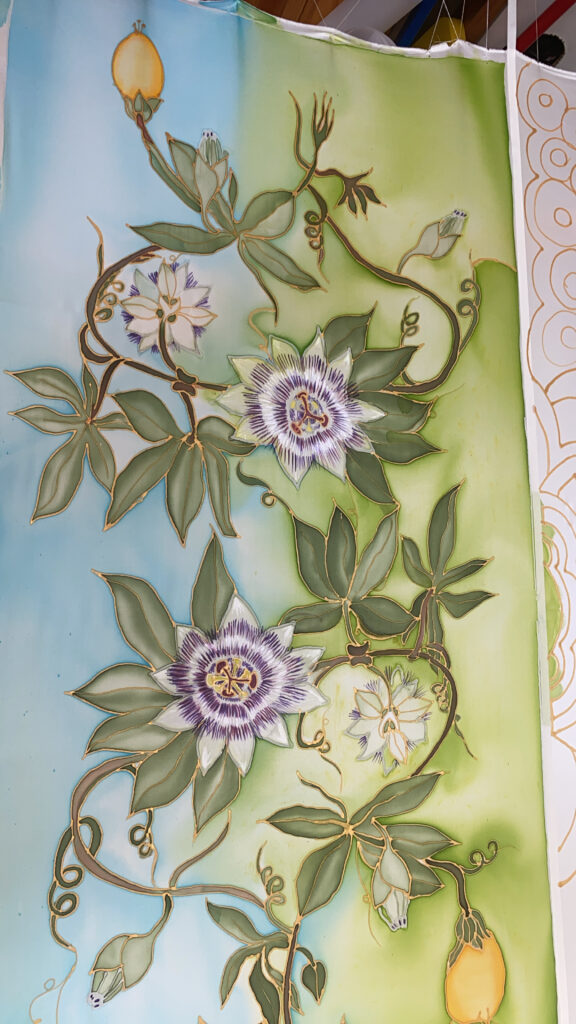 Close-up detail of hand-painted passion flower on silk scarf with botanical vine artwork Enchanted Silks By Zen