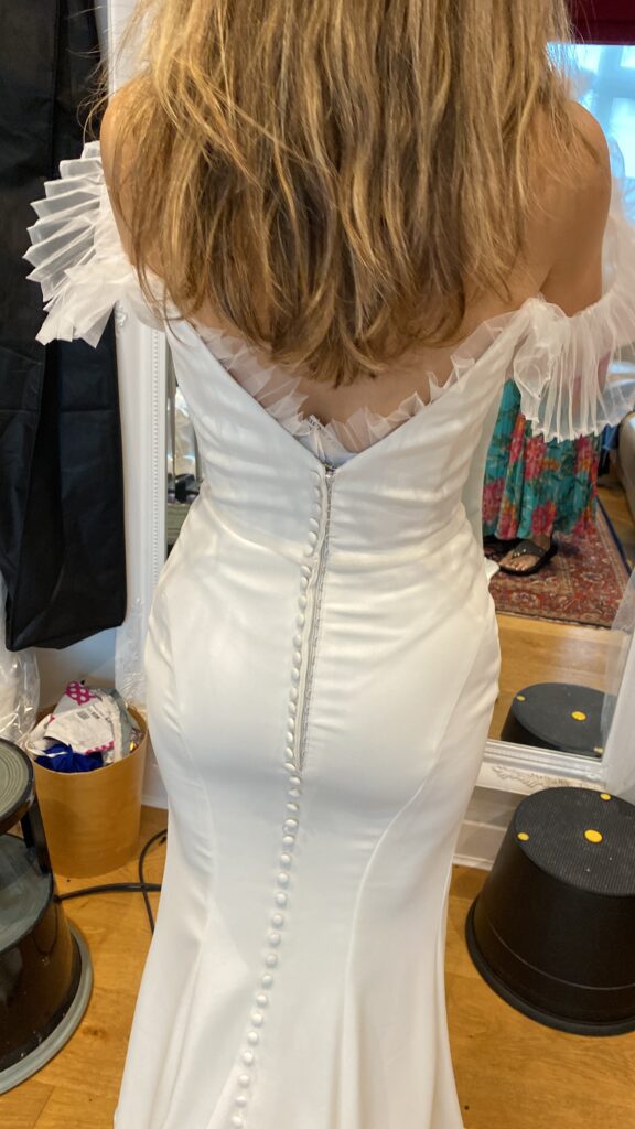 Back final fitting during couture bridal sleeve reconstruction using pleated illusion tulle