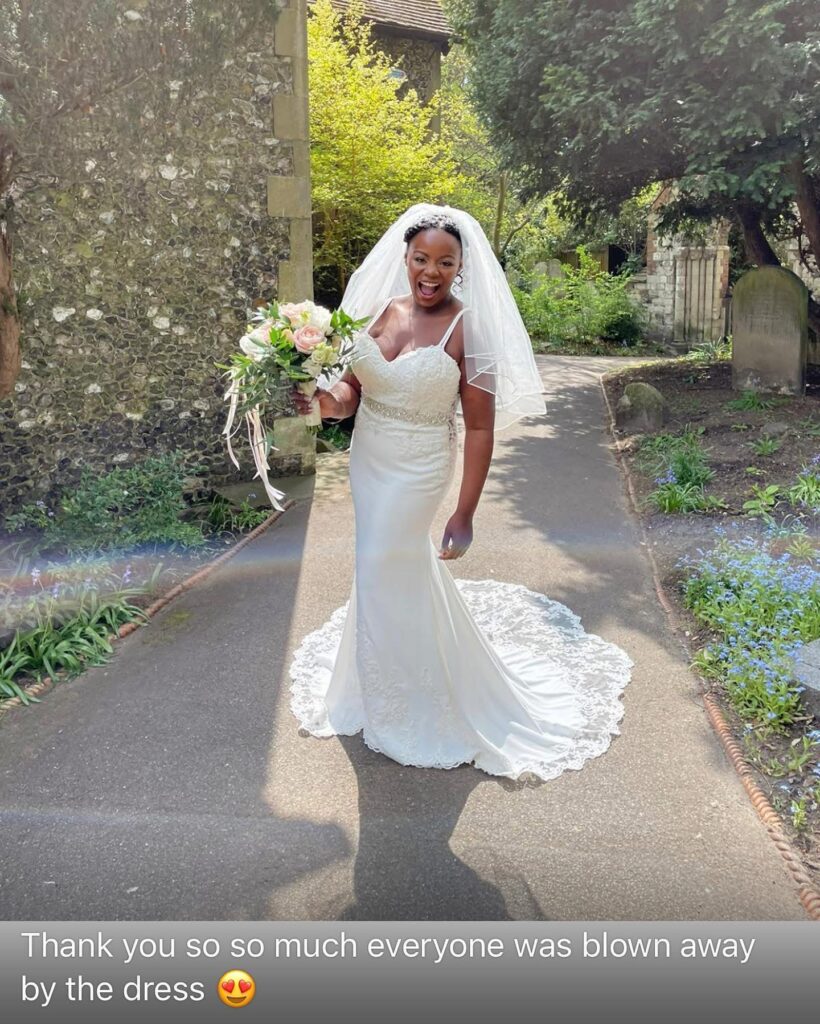 Heavily pregnant bride wearing fitted crepe wedding dress after alterations