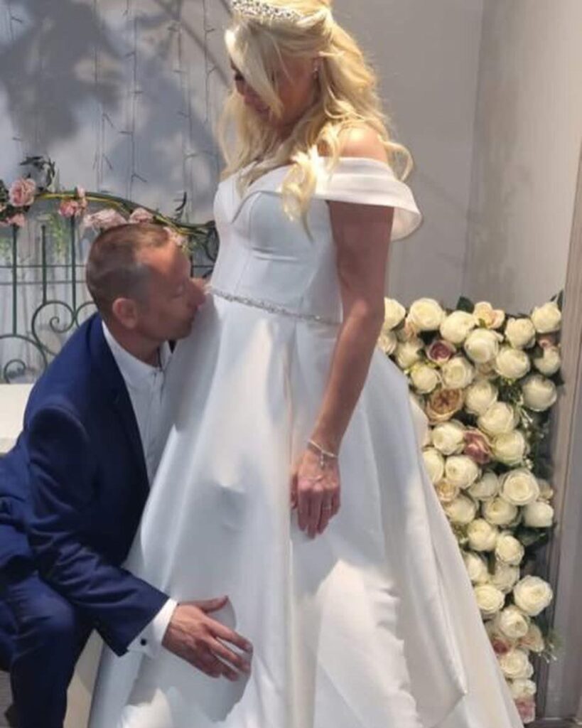 Structured satin wedding dress altered for heavily pregnant bride