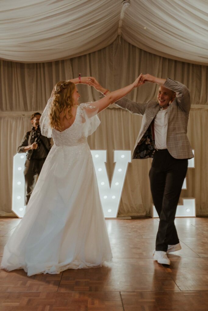 Bride dancing in altered WED2B wedding dress with natural flowing movement