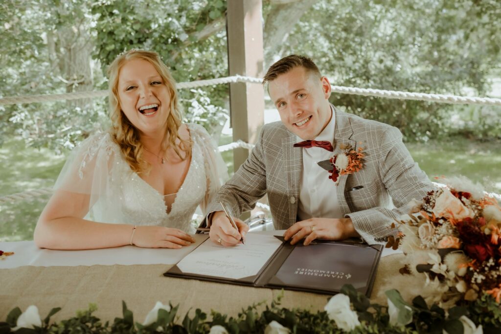 Bride and groom signing wedding register after specialist bridal alteration