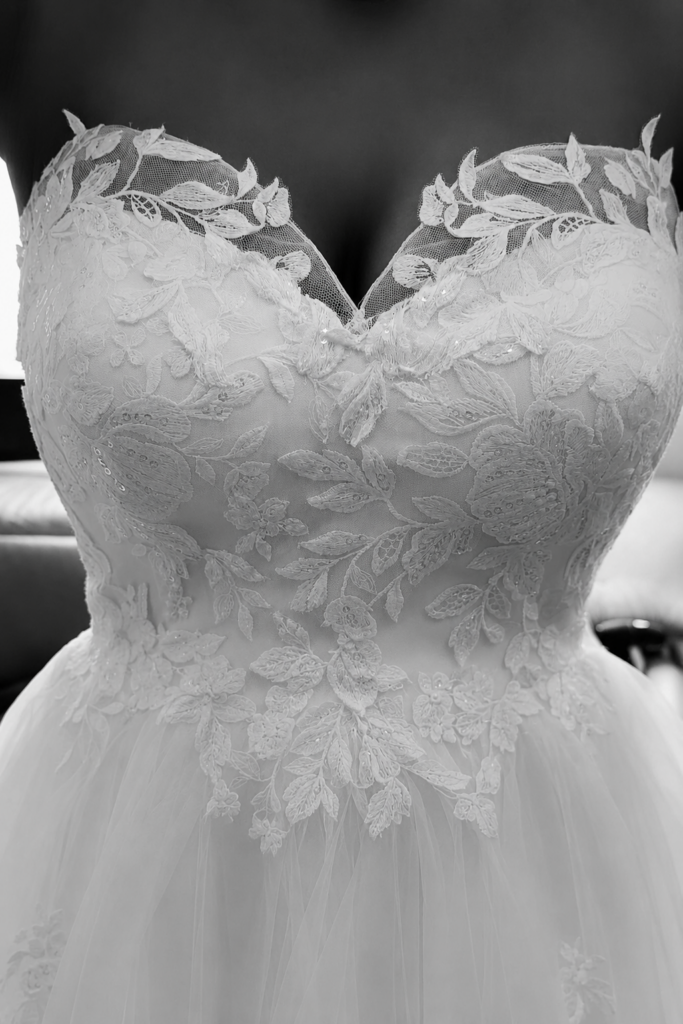 Bride wearing altered WED2B wedding dress with couture modesty panel and reconstructed neckline