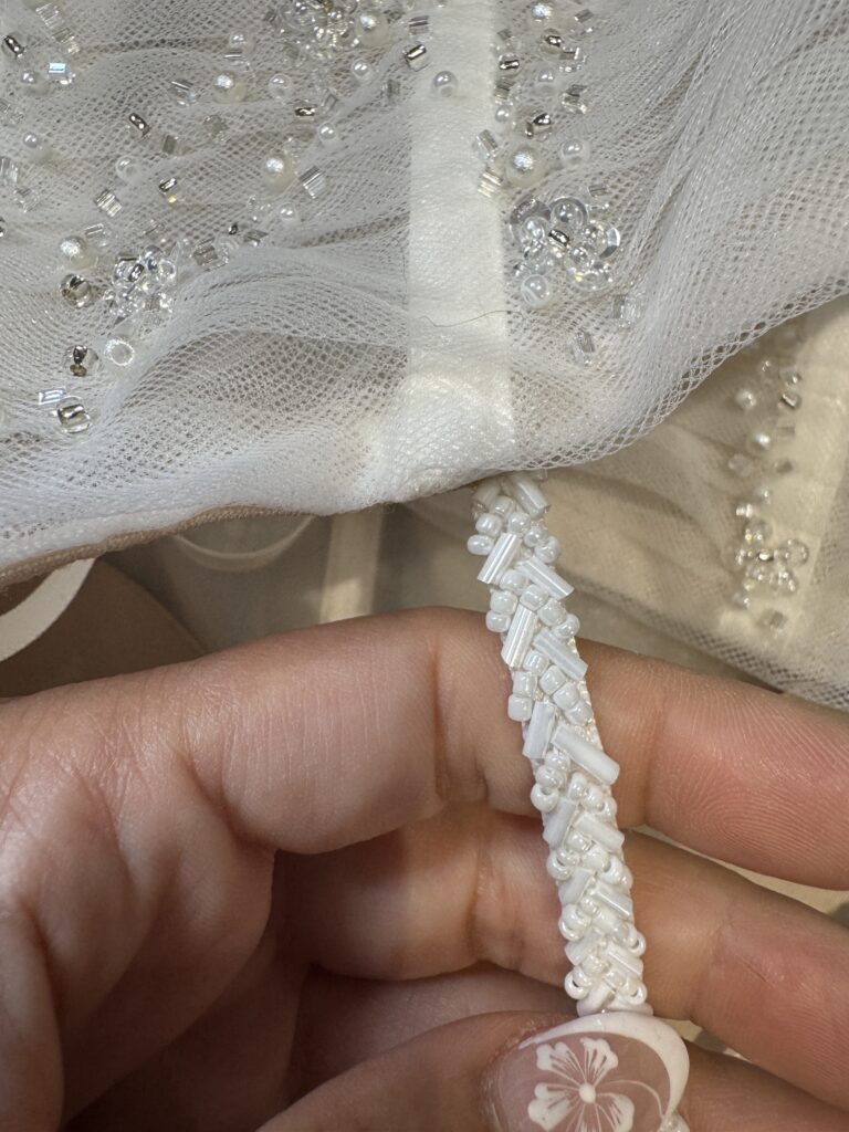 bespoke beaded strap all hand beaded and attached to dress.