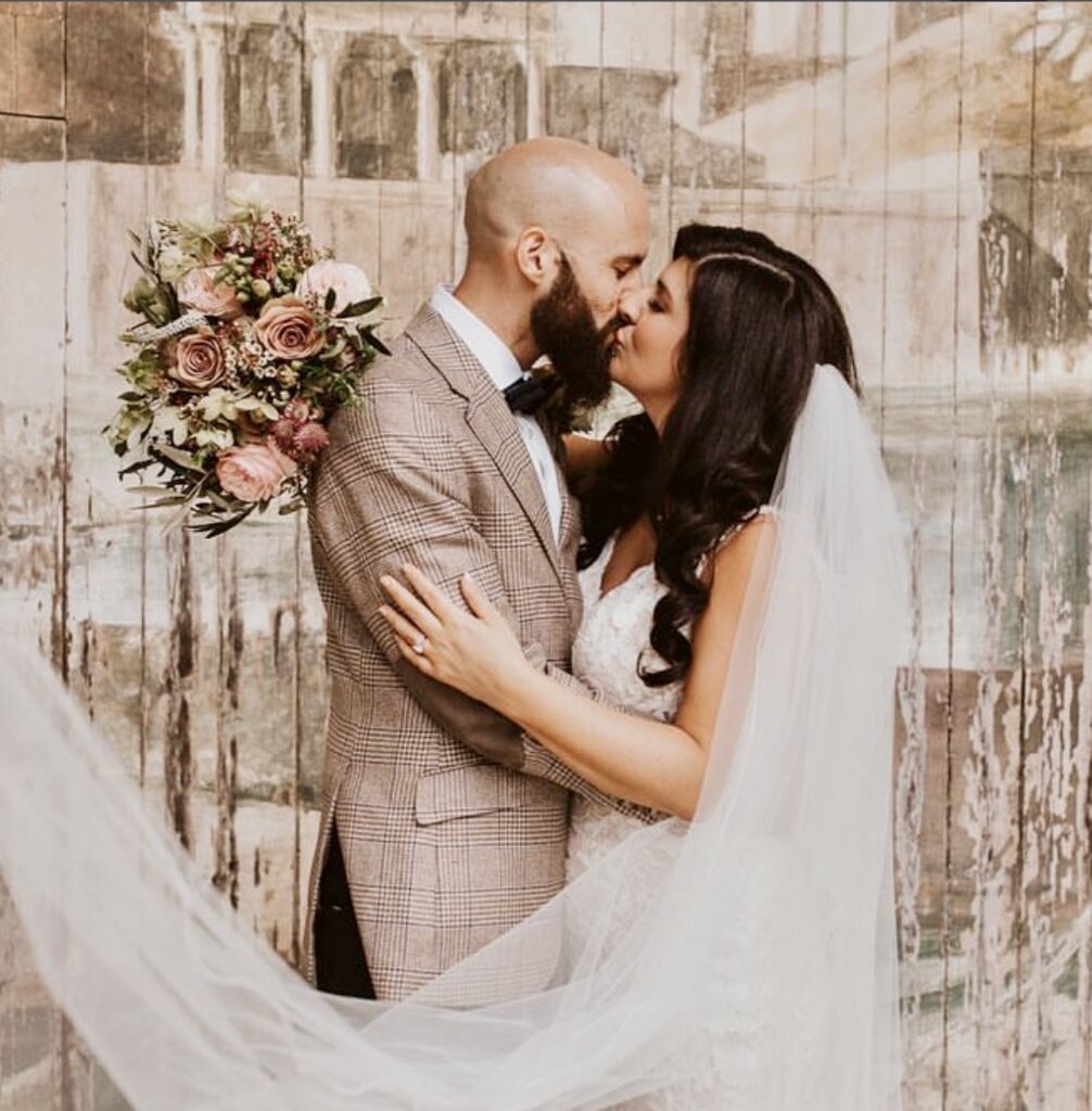 Bride wearing an Allure Bridal wedding dress after expert bridal alterations for her Purley wedding