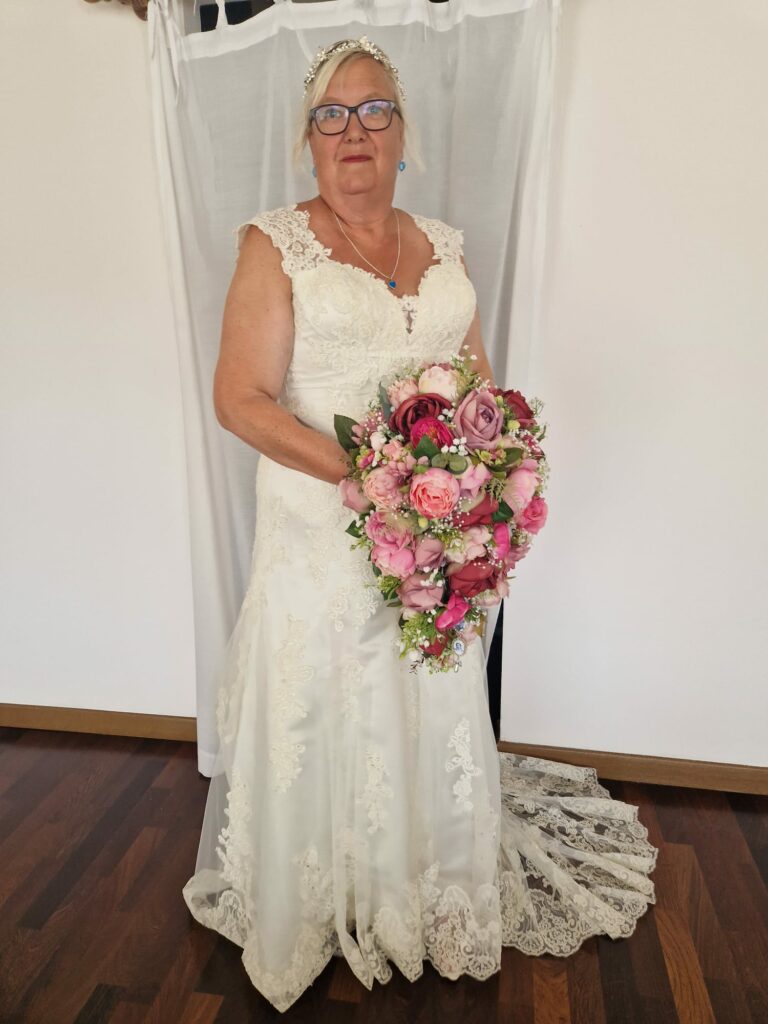 Bride wearing a lace wedding dress at her Cyprus destination wedding after expert sewing adjustments in Sutton, Surrey