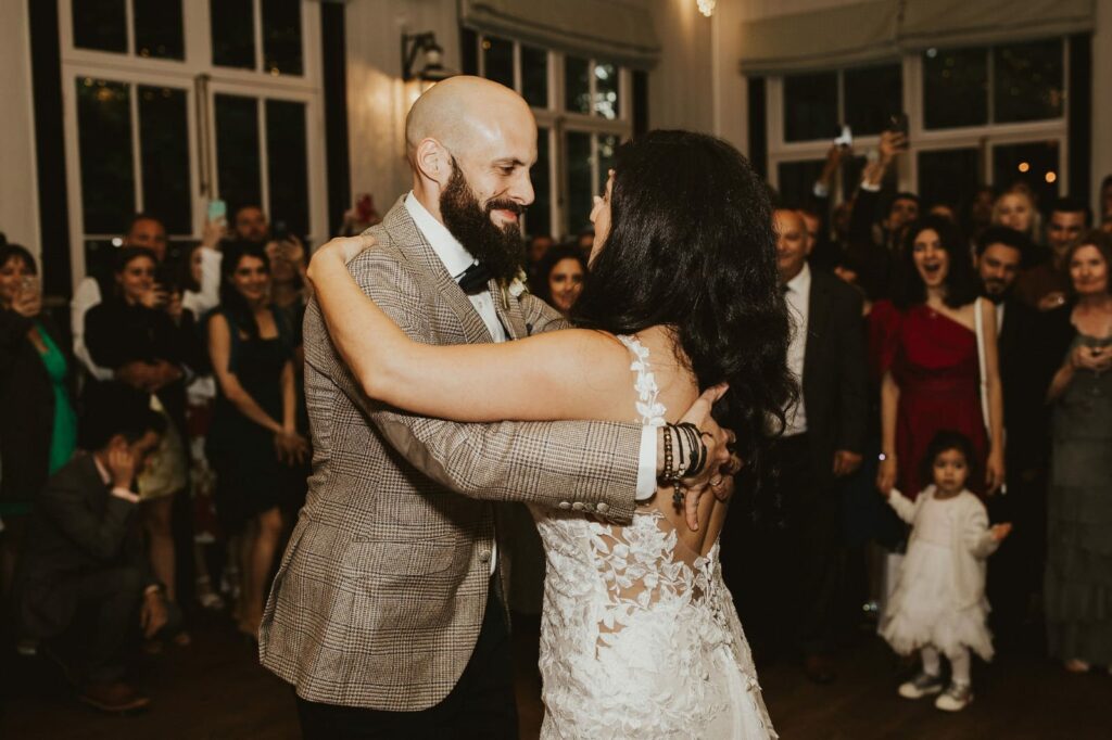 Bride and groom sharing their first dance in an Allure Bridal wedding dress