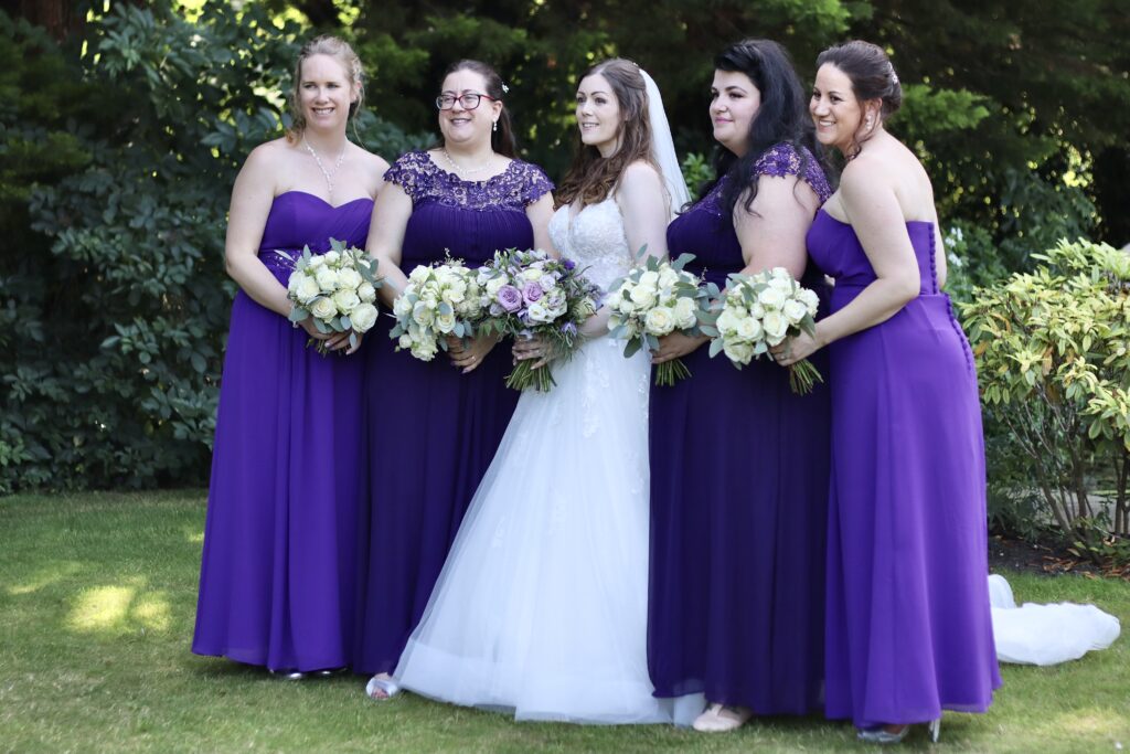Bride wearing customised Stella York wedding dress with bespoke crystal straps and rhinestone belt and embroidery aling back criss cross detail