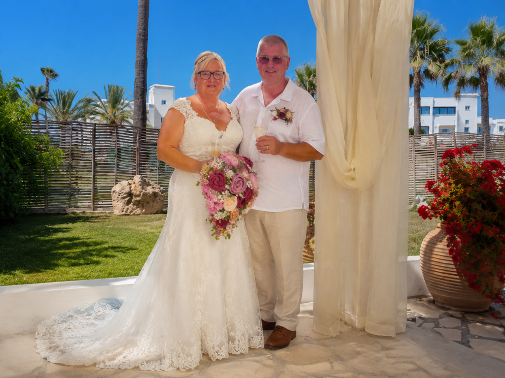 Bride and groom together bride wearing a Symphony of Venus lace wedding dress at her Cyprus destination wedding after expert bridal alterations in Sutton, Surrey