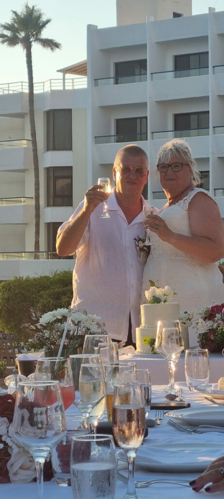 Bride wearing a Symphony of Venus lace wedding dress at her Cyprus destination wedding toast after expert bridal alterations in Sutton, Surrey
