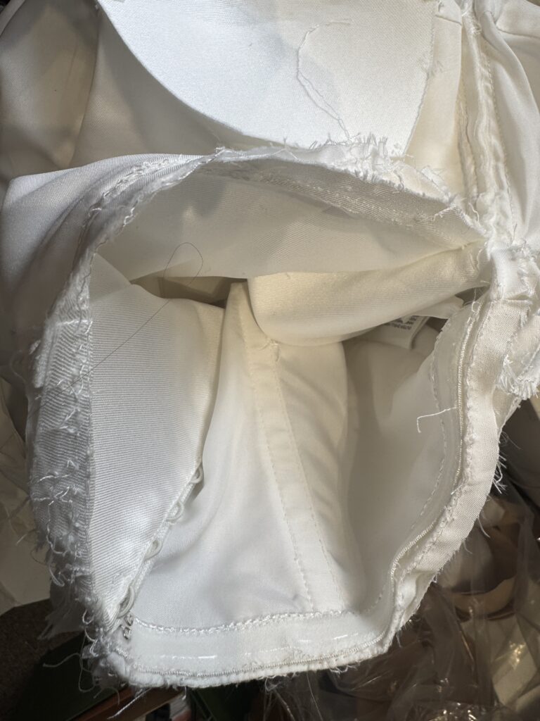 Close up of wedding dress seam reconstruction showing couture level alteration stitching