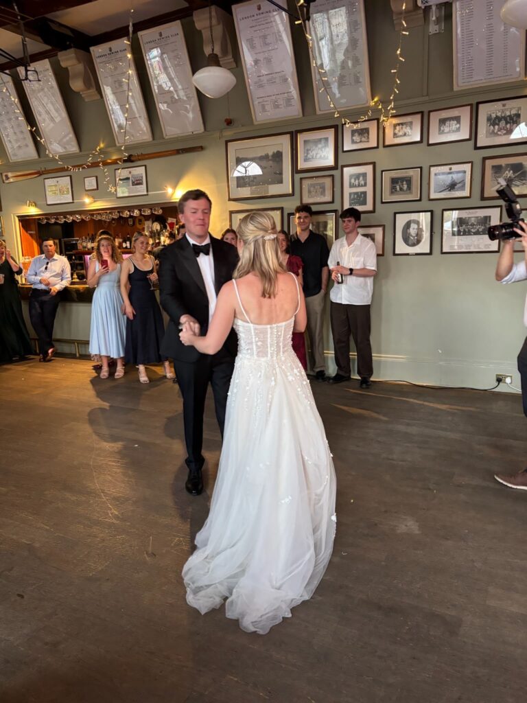 Bride wearing her altered Justin Alexander Florita wedding dress bustled up for first dance with her groom.