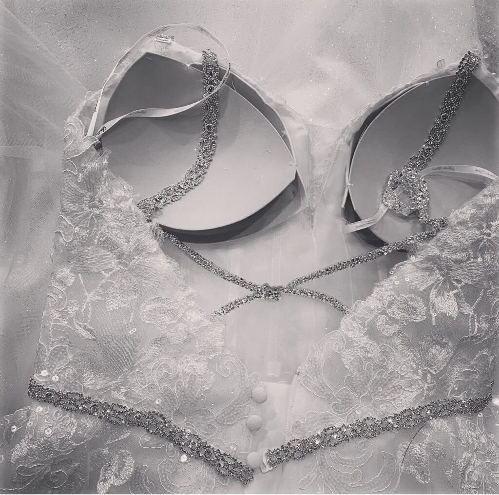 Bride’s customised Stella York wedding dress with bespoke crystal straps and rhinestone belt and bra cups with under & over bust contouring