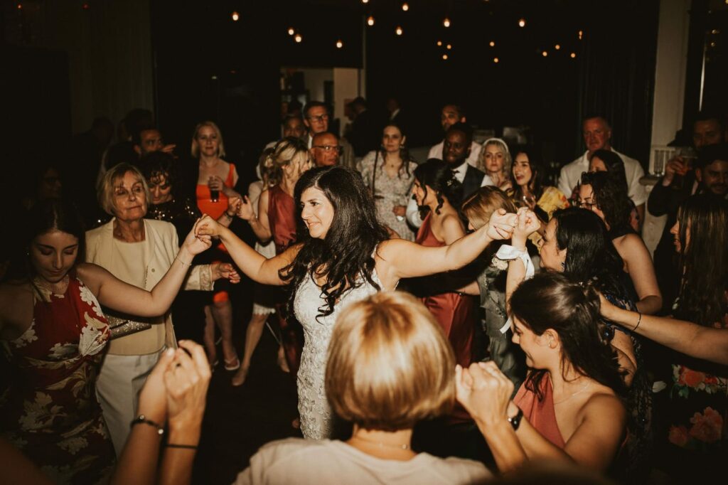 Guests joining the traditional Greek Kalamatiano dance at the wedding reception